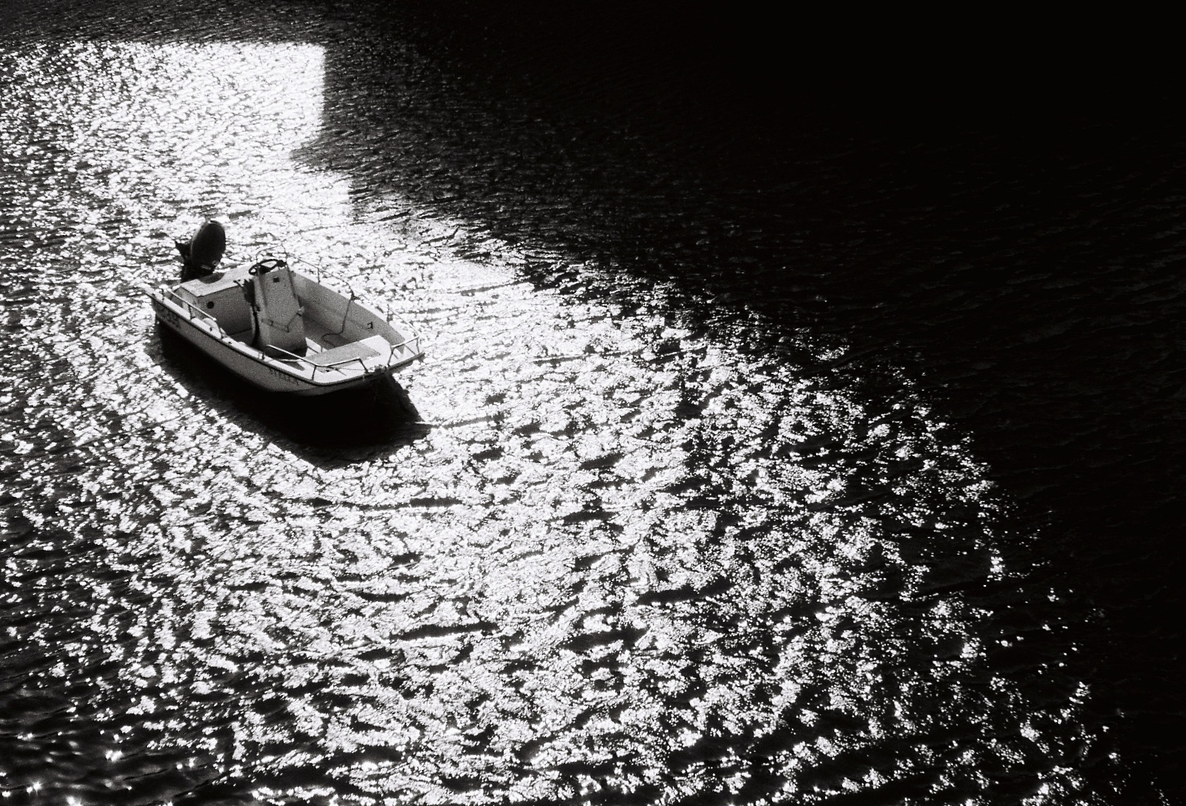 Marseille - A small boat floating on reflective water